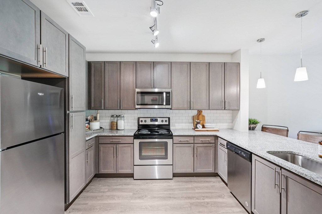 A modern kitchen with stainless steel appliances.